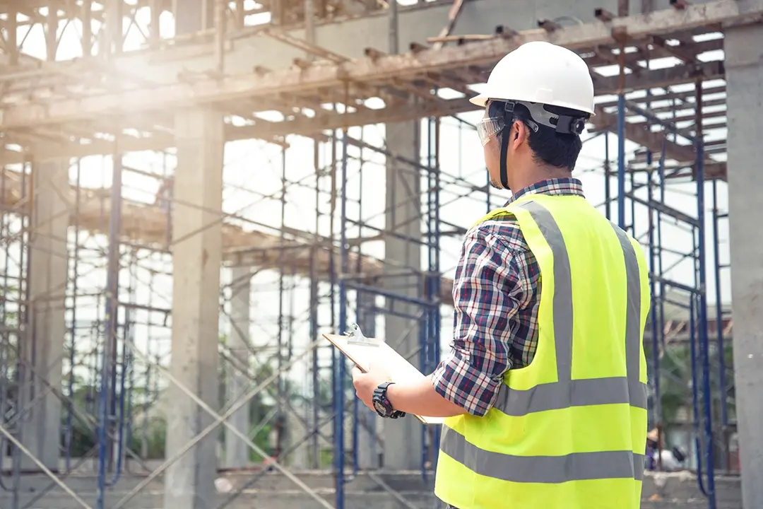 Construction worker reviewing a building site